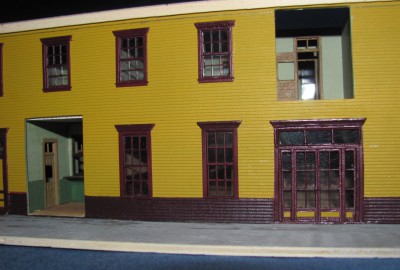 Front entrance with holes for bay windows.