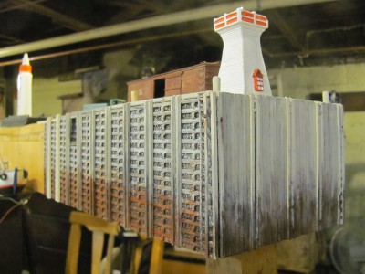 This is my scratchbuilt Kingsport Wharf under construction. Choorch Enterprises makes some great rubber cribwork casting which has speeded construction. The deckwork is all board by board. I am using a resin cast souvenir lighthouses as a stand-in until I built the real Kingsport Lighthouses.