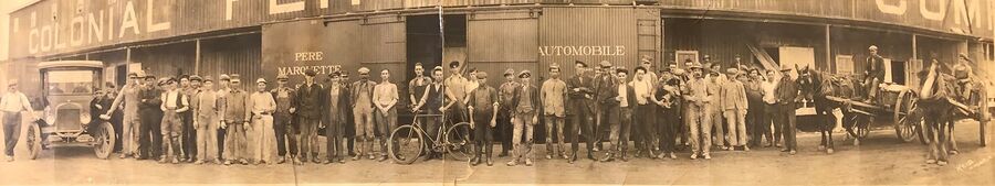 Panoramic photo of workers at the Colonial Fertilizer Plant at loading dock with a Pere Marquette boxcar, 1920.